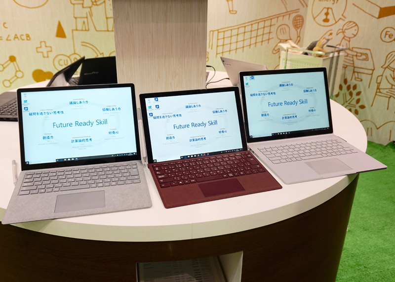 日本マイクロソフトのブースに展示されたSurfaceの端末。右から「<a href="https://www.microsoft.com/ja-jp/surface/devices/surface-book-2/overview">Surface Book 2</a>」「<a href="https://www.microsoft.com/ja-jp/surface/devices/surface-pro/overview">Surface Pro</a>」「<a href="https://www.microsoft.com/ja-jp/surface/devices/surface-laptop/overview">Surface Laptop</a>」。教育用・校務用コンピューターとして、また大学での推奨コンピューターにも選ばれている