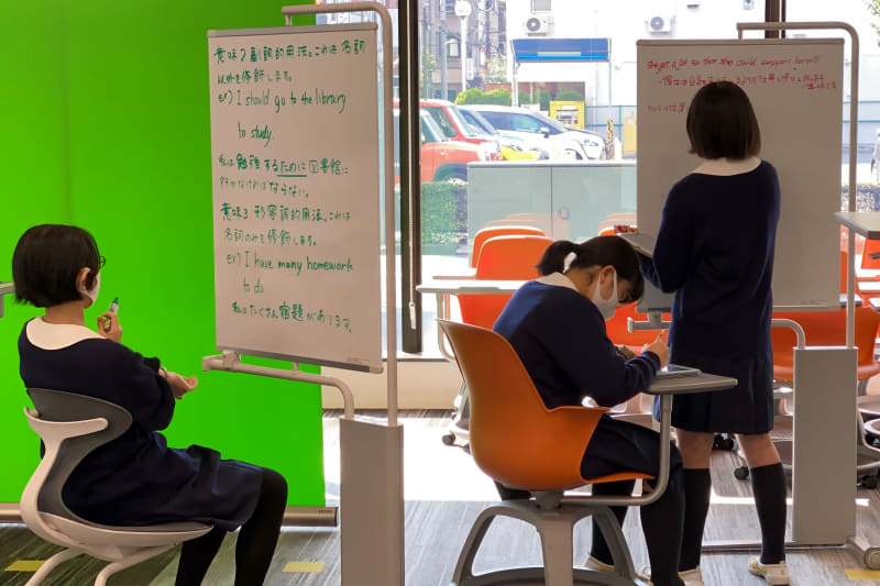 ワンポイント解説動画を作成中のようす。背景の板書とグリーンスクリーンの前で撮った解説動画を合成して仕上げる。「こういう学習は一人ひとり違うものができあがるのが面白い」と品田教諭